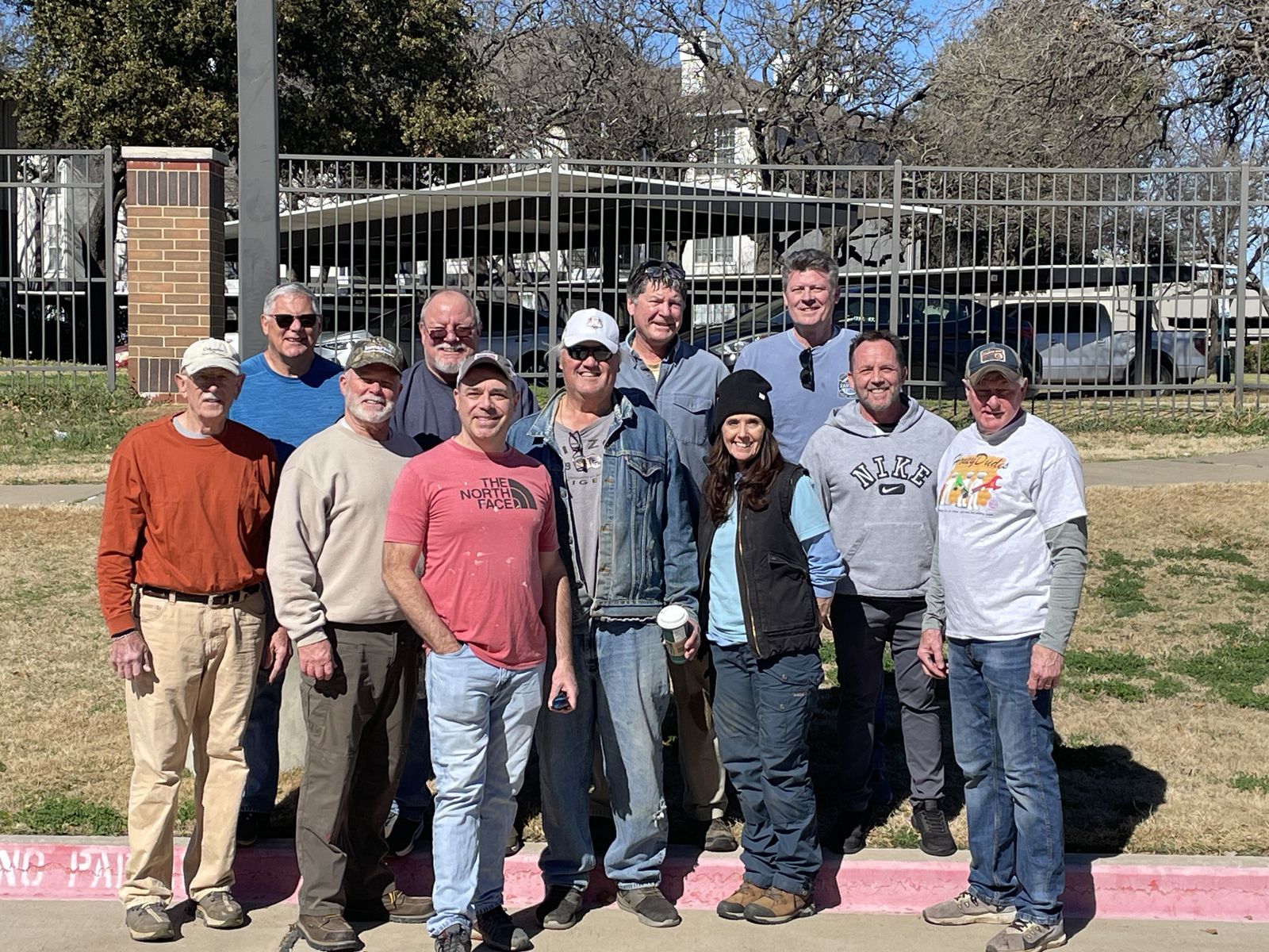 A group of Honey Dudes volunteers posing together outdoors